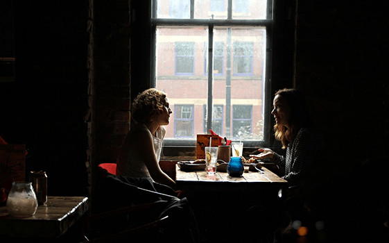 Two women sitting at restaurant in front of a window